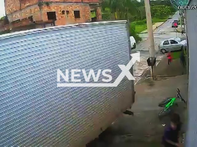 This image is a screen grab of the video supplied titled NewsX-TruckerCrush-01.mp4: Footage shows children narrowly escaping a truck that rolled backward down the street and hit a power pole in Betim, Brazil on Tuesday, Jan. 6, 2025.(Clipzilla)