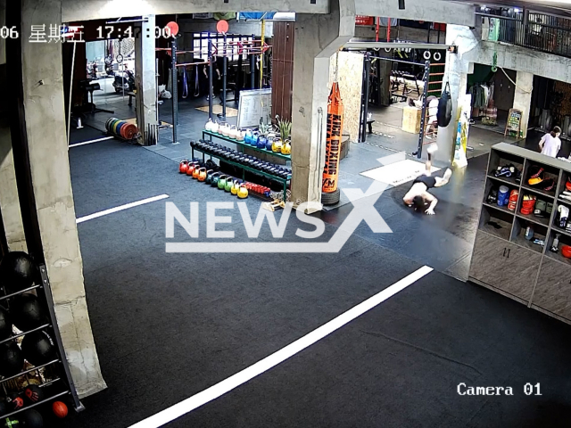 Man slips on wet floor and falls on face when walking upside down in gym in Quanzhou in China on 6th May 2022. Note: This picture is a screenshot from the video (TZL_77777/AsiaWire).