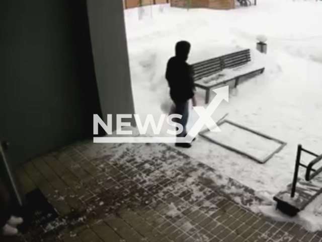 This image is a screen grab of the video supplied titled NewsX-GentleGesture-01.mp4: A man narrowly escapes being crushed by a falling window in Minsk, Belarus, on Jan. 10, 2026. His politeness saved him.(Clipzilla)