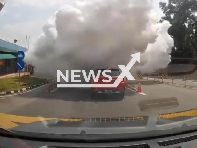 This image is a screen grab of the video supplied titled NewsX-TruckMons-01.mp4: A lorry carrying ammonia cylinders exploded releasing a massive gas cloud that left two toll plaza staff hospitalized at the Seremban Toll Plaza in Malaysia on Thursday, Jan. 15, 2026.(Clipzilla)