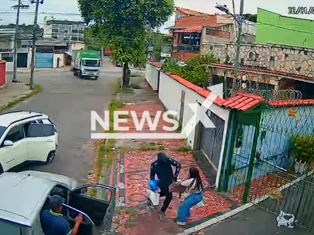 This image is a screen grab of the video supplied titled NewsX-FesCrimi-01.mp4: CCTV shows woman and man being forced into vehicle in Olaria, Rio de Janeiro, Brazil on Tuesday, Jan. 6, 2026.(Clipzilla)