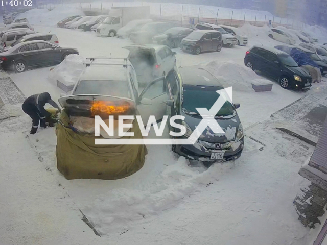 This image is a screen grab of the video supplied titled NewsX-WarmUp-01.mp4: Resident accidentally sets his car on fire while trying to warm it up in freezing temperatures in Novosibirsk, Russia, on 18 January 2026.(Clipzilla)