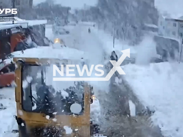 This image is a screen grab of the video supplied titled NewsX-ReversePole-01.mp4: Footage shows a reversing tractor clearing snow hitting a pole housing a 'Safe Region' surveillance camera in Sergiyev Posad, Moscow Oblast, Russia on Friday, Jan. 16, 2026.(Clipzilla)