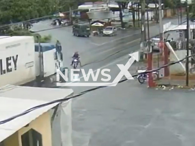 This image is a screen grab of the video supplied titled NewsX-WhoseCollision-01.mp4:  CCTV shows a motorcyclist skidding on rain-soaked pavement, losing control and crashing head-on into a semi-trailer, killing the rider and leaving his passenger seriously injured near the village of Entre Rios , in Puerto Barrios, Guatemala on Monday, Jan. 19, 2026.(Clipzilla)
