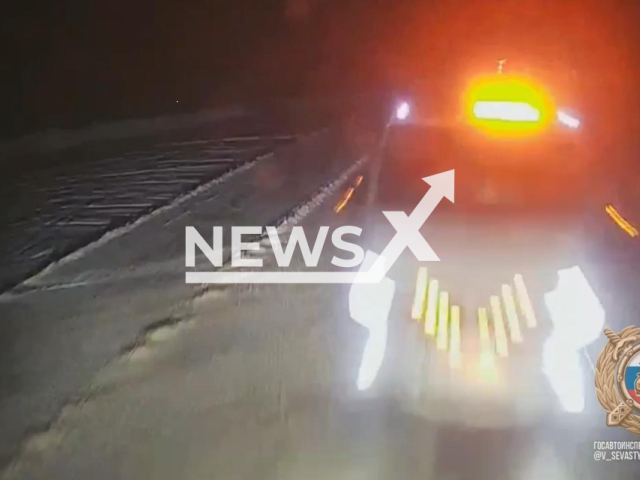 This image is a screen grab of the video supplied titled NewsX-HeadOnCrash-01.mp4:  Footage shows a truck driver swerving into oncoming traffic to avoid a parked car, fatally striking a tow truck driver at the scene in Kushnarenkovsky District, Republic of Bashkortostan, Russia on Monday, Jan. 19, 2026.(Clipzilla)