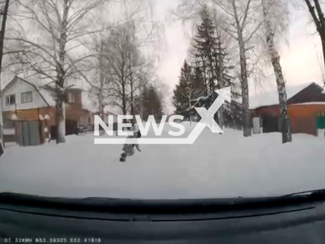 This image is a screen grab of the video supplied titled NewsX-SlipRun-01.mp4: Dashcam shows a schoolboy slipping and falling while crossing in front of an oncoming car, as the driver brakes hard but is unable to fully stop hits the child on snow-packed road in Buguruslan, Orenburg Oblast, Russia on Wednesday, Jan. 7, 2026.(Clipzilla)