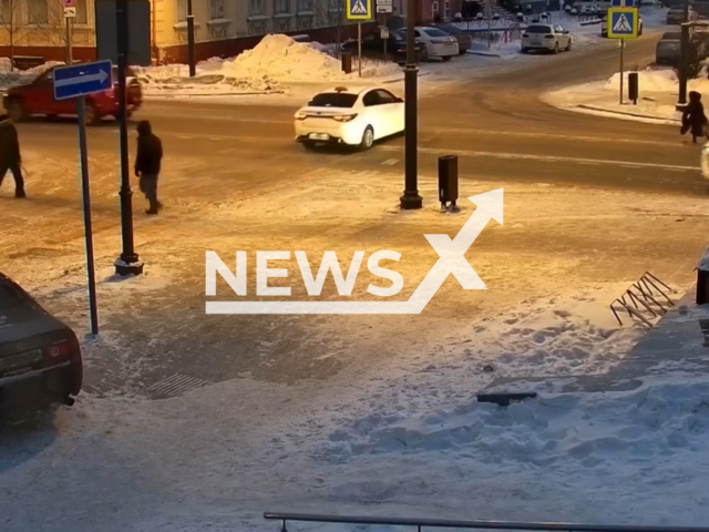 This image is a screen grab of the video supplied titled NewsX-TyumenPedestrian-01.mp4: CCTV shows a woman attempting to cross the road outside a crosswalk being struck by a car, thrown several meters by the impact, as the vehicle then collides with another passing car in Tyumen, Russia on Wednesday, Jan. 28, 2026.(Clipzilla)