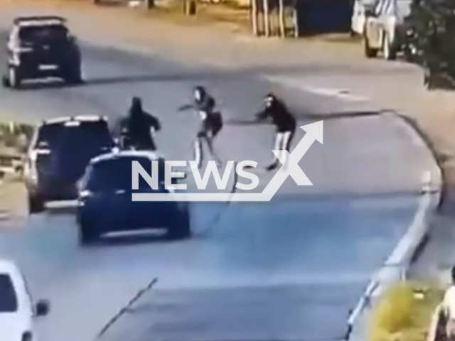 This image is a screen grab of the video supplied titled NewsX-ThiefRobbery-01.mp4: Footage shows a thief entering the highway to rob a motorcyclist and was struck by a policewoman driving her personal vehicle in Quilmes, Buenos Aires, Argentina on Friday, Jan. 30, 2026.(Clipzilla)