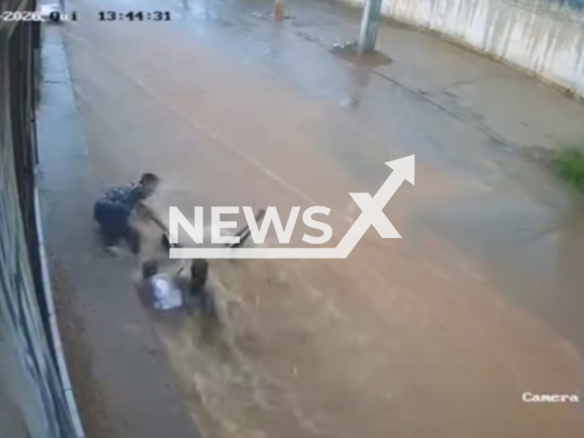 This image is a screen grab of the video supplied titled NewsX-SwepFlods-01.mp4: Footage shows a mother and daughter being swept away by the floodwaters during a storm in Valparaiso de Goias,Brazil on Thursday, Jan. 29, 2026.(Clipzilla)