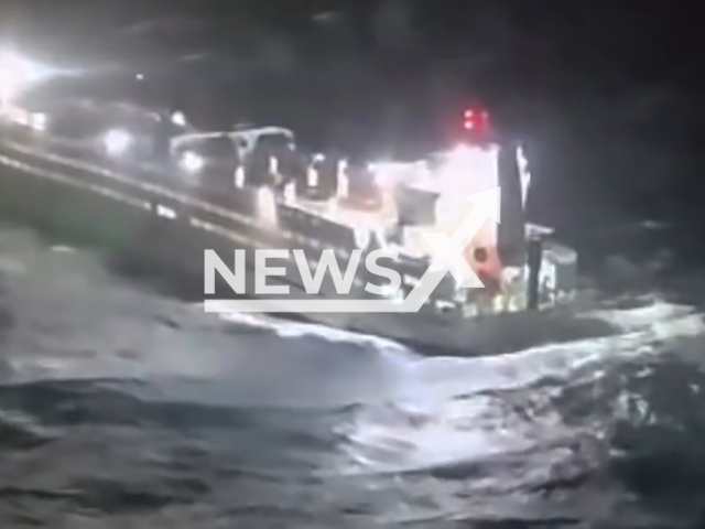 This image is a screen grab of the video supplied titled NewsX-SinkGurd-01.mp4: Footage shows a dramatic rescue operation as the cargo vessel Blue Ocean A, disabled by an engine failure, is saved from being dragged by powerful winds and waves toward the rocky coast with 33 crew members on board near Carloforte, Sardinia, Italy on Wednesday, Jan. 28, 2026.(Clipzilla)