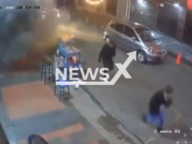 This image is a screen grab of the video supplied titled NewsX-ColombienGrens-01.mp4: CCTV shows a powerful explosion moments after two men on a motorcycle throw a grenade, which detonates seconds later, causing chaos, injuries, and one fatality in Bogota, Columbia on Thursday, Jan. 22, 2026.(Clipzilla)