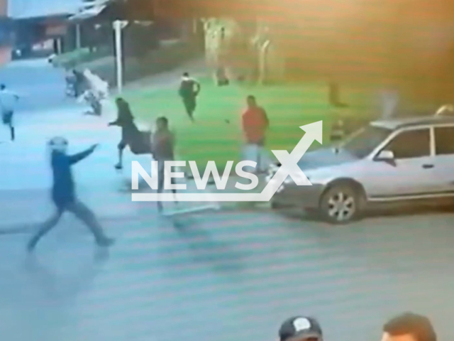 This image is a screen grab of the video supplied titled NewsX-HitmenMot-01.mp4: Mother throws herself against gunman to try and prevent her children's murder in Neropolis, Goias, Brazil on Sunday, Feb. 1, 2026.(Clipzilla)