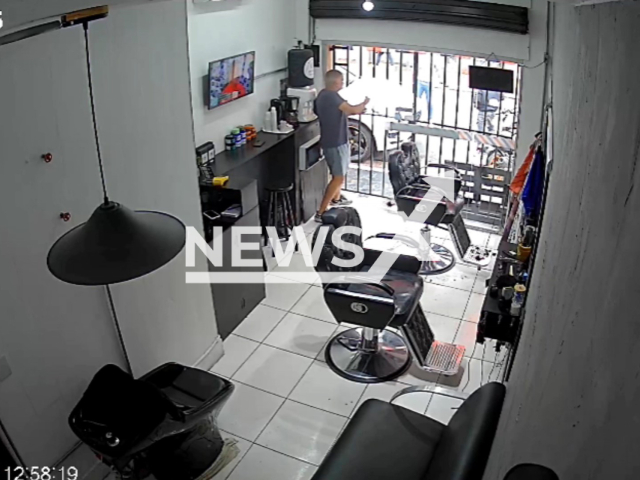 This image is a screen grab of the video supplied titled NewsX-ShooterPorsches-01.mp4: Footage shows off-duty police officer killing the suspect in robbery attempt inside a barbershop in Sacoma, Sao Paulo, Brazil on Tuesday, Feb. 3, 2026.(Clipzilla)