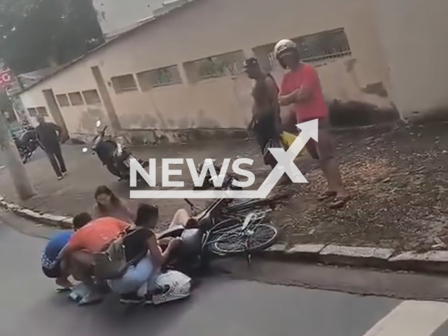 A motocyclist falls while stopping to observe an accident in Governador Valadares, Brazil, on Feb.04,2026. She lost her balance and fell on the people who were providing first aid. Note: Photo is a screenshot from the video (Newsflash)
