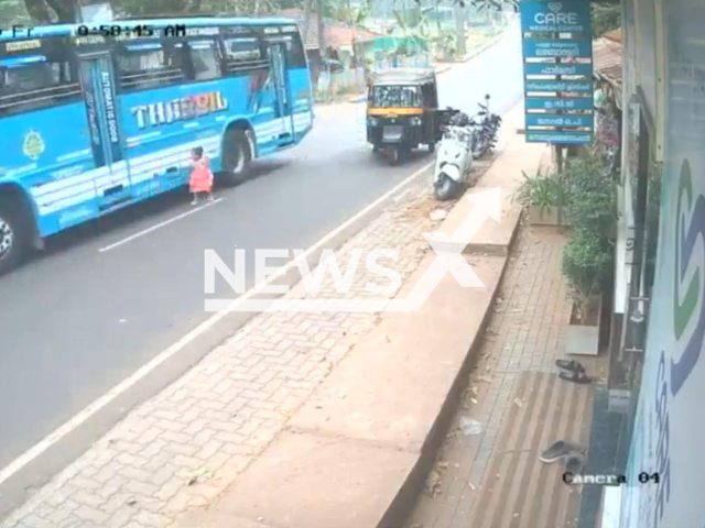 This image is a screen grab of the video supplied titled NewsX-BusChild-01.mp4: Footage shows a bus swerving as a 3-year-old child runs across the street and stops just in time, narrowly avoiding being run over in Kozhikode district, Kerala, India on Friday, Jan. 30 2026.(Clipzilla)
