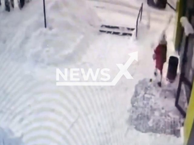 This image is a screen grab of the video supplied titled NewsX-SnowFall-01.mp4: Footage shows a mass of snow felling from a roof onto 11-year-old girl who was walking to school along the building in Kirov, Kirov Oblast, Russia on Thursday, Feb. 5, 2026.(Clipzilla)