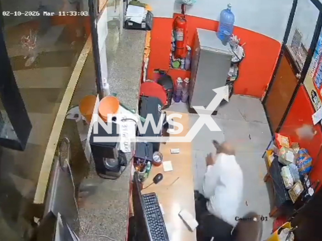 This image is a screen grab of the video supplied titled NewsX-EsmeraldasShooting-01.mp4: CCTV shows a masked gunman opening fire at a ticket office inside bus terminal as the worker quickly dives under the desk to avoid the bullets and narrowly escapes unharmed in Esmeraldas, Ecuador on Tuesday, Feb. 10, 2026.(Clipzilla)