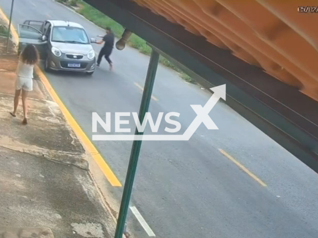 This image is a screen grab of the video supplied titled NewsX-RescuedBros-01.mp4: CCTV shows a barber Ramon Miranda, 27 jumping into runaway car rolling downhill and saves the children in the Parque Xangri-La neighborhood, in Contagem, Brazil on Friday, Feb. 6, 2026.(Clipzilla)