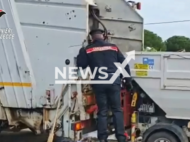 This image is a screen grab of the video supplied titled NewsX-OfficerMotherBaby-01.mp4: Footage shows police officers recovering a casket containing 20 gold bars after a man accidentally threw it into the garbage in Porto Cesareo, Italy, according to a statement from Feb. 12, 2026(Carabinieri/Clipzilla)