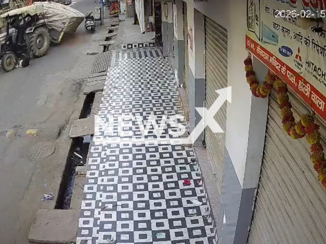 This image is a screen grab of the video supplied titled NewsX-TractorRoad-01.mp4: Footage shows a road suddenly collapsing beneath a heavily loaded tractor sending the trolley plunging into the sinkhole as the driver is thrown to the ground and narrowly escapes death in Agra, Uttar Pradesh, India on Sunday, Feb. 15, 2026.(Clipzilla)
