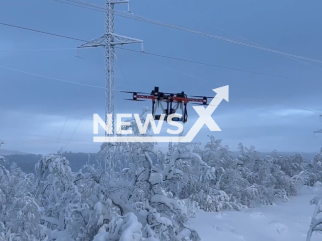 This image is a screen grab of the video supplied titled NewsX-SpiderDrone-01.mp4: Footage shows the “Spider” drone system successfully clearing ice and frost from overhead power lines during a test operation in Murmansk Region, Russia on Thursday, Feb. 12, 2026.(Clipzilla)