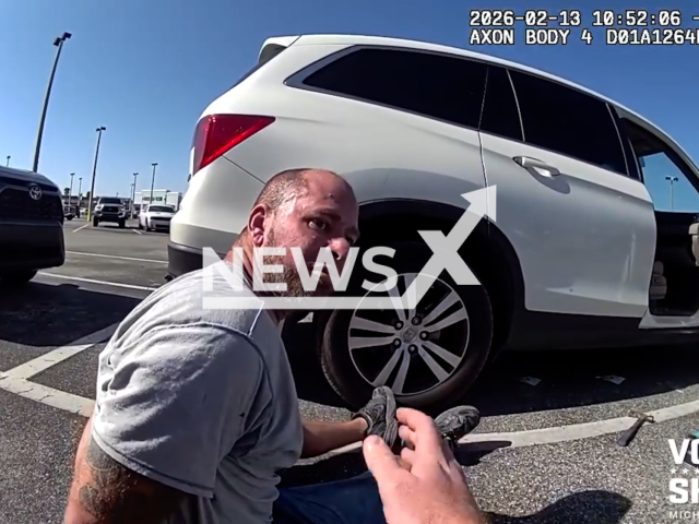 This image is a screen grab of the video supplied titled NewsX-WrongCar-01.mp4: Footage shows police officers arresting Justin Allen, 37 while destroying a SUV that he thought its belonged to his ex in a Publix parking lot, Ormond-by-the-Sea, Florida, United States on Friday, Feb. 13, 2026.(@volusia.sheriff/Clipzilla)