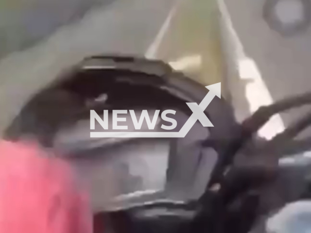 This image is a screen grab of the video supplied titled NewsX-LikesBikers-01.mp4: Footage shows biker Icaro Lima fatally crashing after riding his motorcycle with only one hand on the handlebars while using his cell phone in Salvador, Bahia, Brazil on Saturday, Feb. 14, 2026.(Clipzilla)