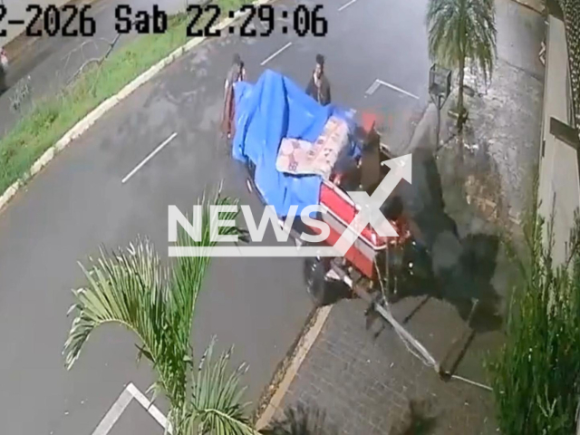 This image is a screen grab of the video supplied titled NewsX-GerBot-01.mp4: CCTV shows footage shows thieves arriving at a property, breaking into a garage, and stealing a boat and trailer in under a minute before fleeing on foot in Uberlandia, Brazil on Saturday, Feb. 14, 2026.(Clipzilla)