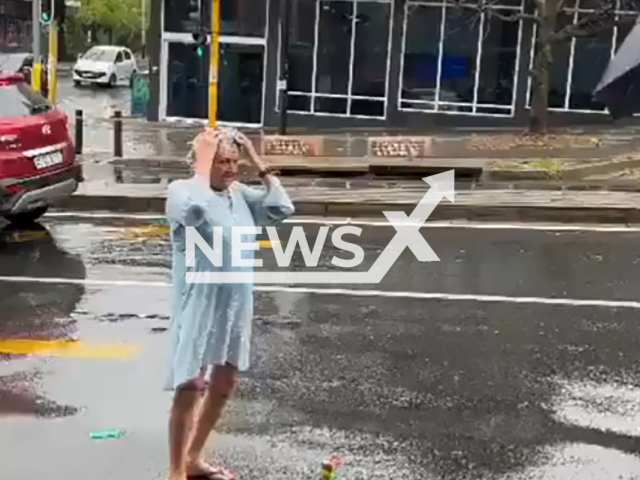 A woman takes a shower in the rain in Melville, South Africa, undated. She protested against the water crisis. Note: Photo is a screenshot from the video (Newsflash)