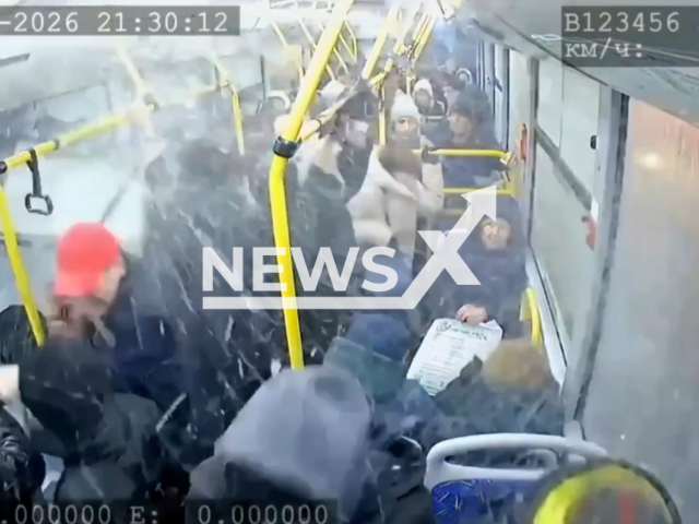 This image is a screen grab of the video supplied titled NewsX-RoadSign-01.mp4: Footage shows a road sign being blown off by strong winds and crashing into the window of a moving bus in Voronezh, Croatia on Monday, Feb. 16, 2026.(Clipzilla)