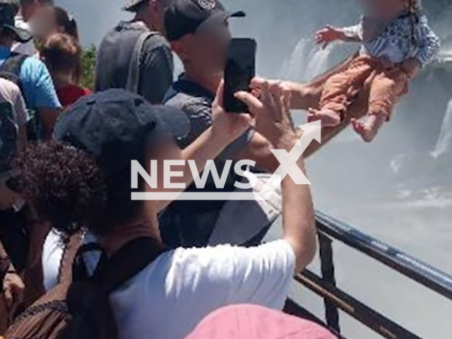 Picture shows the man holding the baby at the Devil's Throat, Iguazu Falls, Argentina, on Feb.17,2026. He was slammed for risking the baby's life. Note: Private photo. (Newsflash)