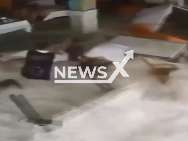 This image is a screen grab of the video supplied titled NewsX-RestaurantEmployee-01.mp4: Footage shows wave, dragging the cleaning staff, tables and chairs in the restaurant in Alanya, Turkey on Wednesday, Feb. 18, 2026.(Clipzilla)