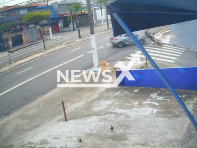 This image is a screen grab of the video supplied titled NewsX-RecklessManeuver-01.mp4: Security footage shows a drunk driver making an illegal turn fatally striking 39-year-old police officer Diego Richard Ferreira de Souza as he rode home from his overnight shift. on Avenida Sao Miguel in Sao Paulo’s East Zone, Brazil on Sunday, Feb. 22, 2026.(Clipzilla)