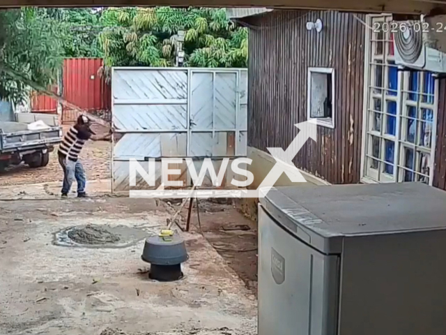 This image is a screen grab of the video supplied titled NewsX-WoodenBeam-01.mp4:Footage shows a wooden beam falling on Doroteo Sosa Quinonez, 58, as he attempted to open a gate, resulting in a fatal injury in Ciudad del Este, Paraguay, on Tuesday, Feb. 24, 2026.(Clipzilla)