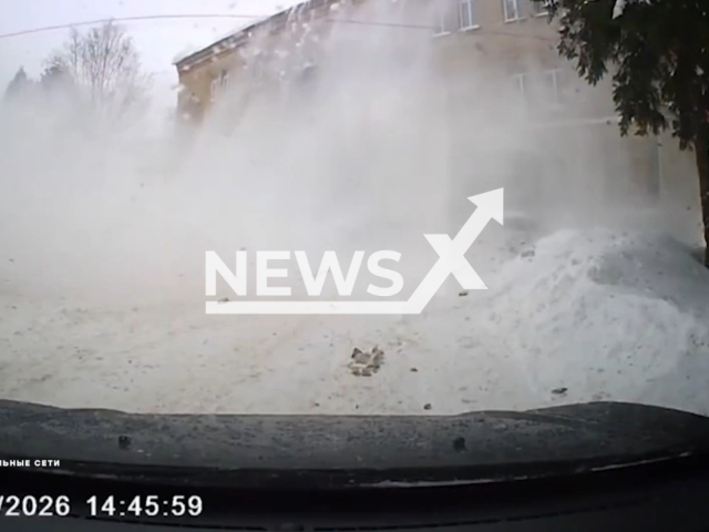 This image is a screen grab of the video supplied titled NewsX-RoofAvalanche-01.mp4: Footage shows an avalanche felling from a building's roof onto parked cars in Uglich, Yaroslavl Oblast, Russia on Sunday, Feb. 22, 2026.(Clipzilla)
