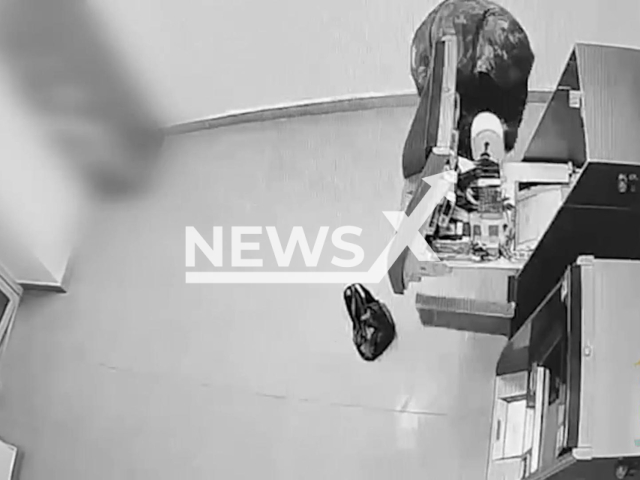 This image is a screen grab of the video supplied titled NewsX-ATMHeist-01.mp4: Footage shows a 34-year-old man in camouflage attempting to break into an ATM but fled in panic after the alarm sounded, and was later arrested by police in Ufa, Bashkortostan, Russia, undated. The Ministry of Internal Affairs of Bashkortostan released the footage on Thursday, Feb 26, 2026.(Clipzilla)