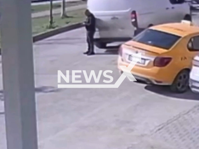 This image is a screen grab of the video supplied titled NewsX-PhoneManRoadTruck-01.mp4:  Footage shows a panel van, reversing, hitting a pedestrian who was preoccupied with his cell phone in Adana, Turkey, on Tuesday, Feb. 24, 2026(Clipzilla)