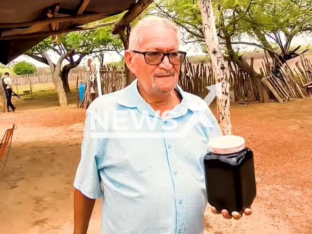 Sidronio Moreira holds a jar of possible oil he found while drilling a well in Tabuleiro do Norte, Brazil. The discovery went viral on social media on Monday, 23 February 2026. Note: Photo is a screenshot of a video. (Newsflash)