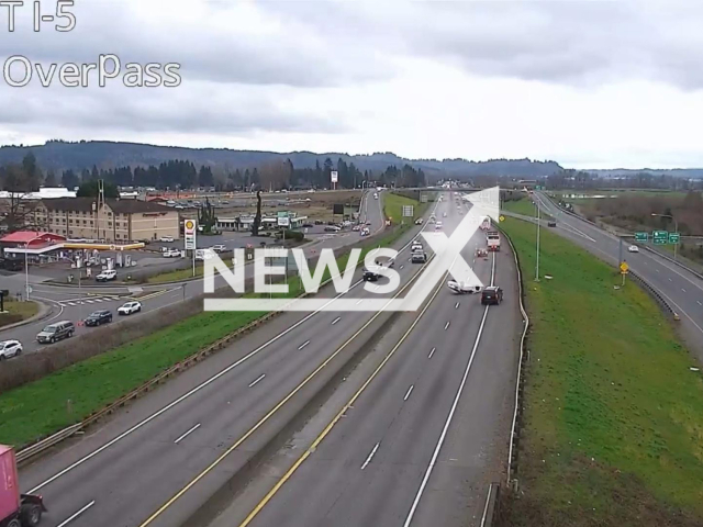 This image is a screen grab of the video supplied titled NewsX-SkiddingCar-01.mp4: DOT camera footage shows a car sliding on its roof for about 400 feet along Interstate 5 after a high-speed police pursuit in Washington, with an infant later found inside the vehicle but unharmed in Castle Rock, Washington, United States on Tuesday, Mar. 3, 2026.(Clipzilla)