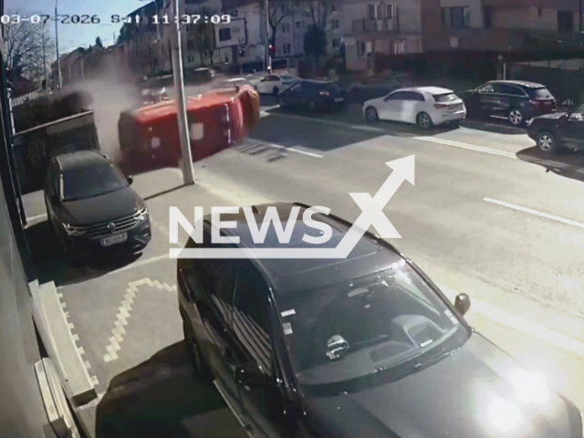 This image is a screen grab of the video supplied titled NewsX-SibiuAmbulance-01.mp4: Footage shows a SMURD ambulance overturing after being hit by a car on a street in Sibiu, Romania on Saturday, Mar. 7, 2026.(Clipzilla)