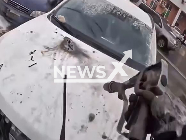 This image is a screen grab of the video supplied titled NewsX-PowerHood-01.mp4: Footage shows a live power line falling onto a parked SUV in Samara, burning through the hood and sparking a small engine fire before firefighters arrived to extinguish it in Samara, Russia on Saturday, Mar. 7, 2026.(Clipzilla)