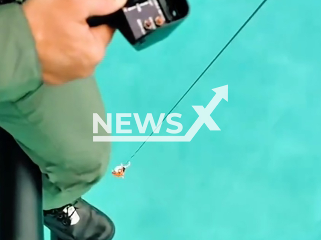 This image is a screen grab of the video supplied titled NewsX-DriftRescue-01.mp4: Footage shows rescue crews using a helicopter winch to lift a 32-year-old woman from a sailboat adrift with a torn sail after she required medical assistance off Caponga Beach in Cascavel, Ceara, Brazil, on Sunday, Mar. 8, 2026.(@sspds_ce/Clipzilla)