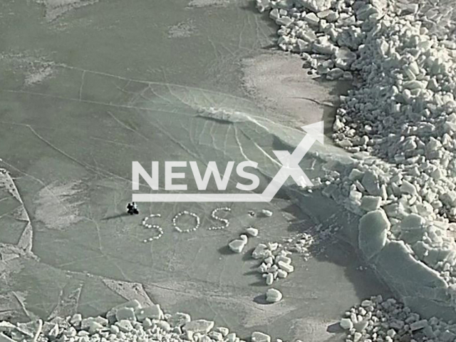Picture shows the SOS message written on ice at Bay of Bothnia, March 11, 2026. They were rescued after ice cracked beneath their tent. Note: Government photo. (Western Finland Coast Guard/Newsflash)