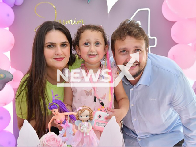 Sara Bianca Moyses Fabian Schneider and Sergio Fabian Schneider pose with a child in undated photo. She was killed in Sao Lourenço do Oeste, Brazil. Note: Private photo taken from social media. (Newsflash)
