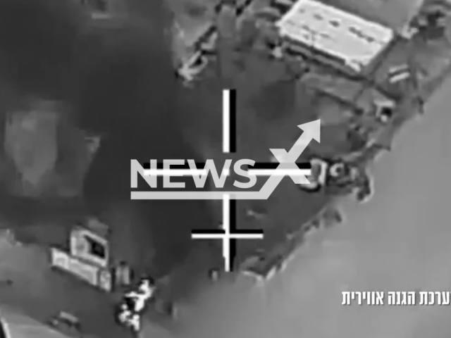 This image is a screen grab of the video supplied titled NewsX-RooftopStrike-01.mp4: Footage shows Israeli Air Force strikes targeting Iranian air defence systems with dramatic scenes of a rooftop hit where two people are seen hanging from the edge of a building and one appears to fall in  in Tehran, Iran on Mar. 31, 2026.(Clipzilla)