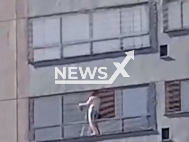 A woman cleans window without safety equipment 35 meters from the ground in Goiania, Brazil, March 31, 2026. Note: Photo is a screenshot from a video. (Newsflash)