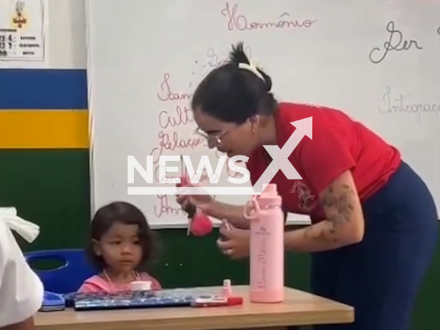 Teacher takes care of student's daughter in the classroom in Augustinopolis, Brazil, March 28, 2026. Note: Photo is a screenshot from a video. (Luana Patricia Garcia/Newsflash)