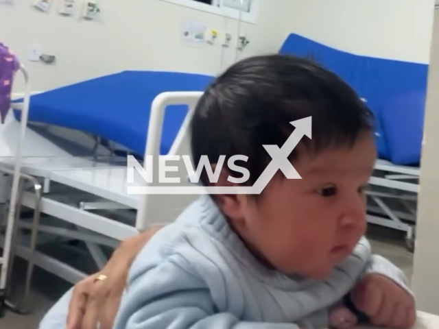 Footage shows newborn baby holding her head up just 10 hours after being born in  Mineiros, Brazil. The video went viral on social media. Note: Photo is a screenshot from a video. (@iraidesrosa/Newsflash)