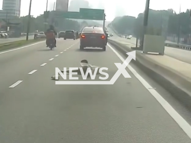 A woman jumps out of a moving car in Klang, Malaysia, on May 01,2026. She reportedly felt anxious through the journey. Note: Photo is a screenshot from a video. (Newsflash/NX)