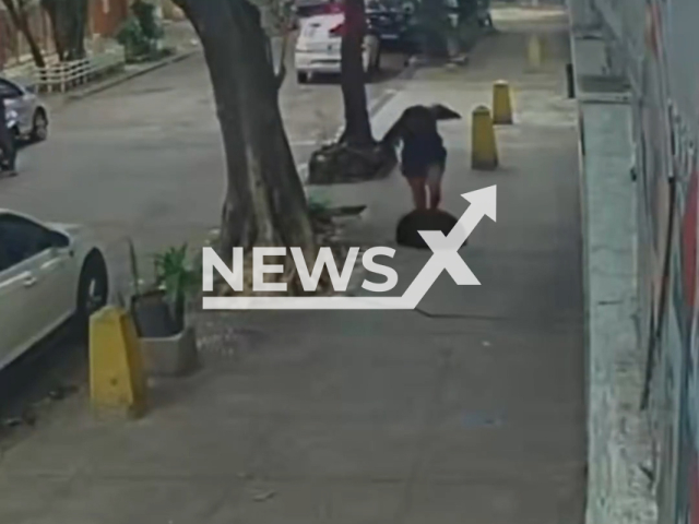 A woman, 32, falls into a manhole on Sunday, May 31, 2026, in  Rio de Janeiro, Brazil.  A camera caught men tampering with it hours earlier an attempted theft. Note: Photo is a screenshot from a video. (Newsflash/NX)